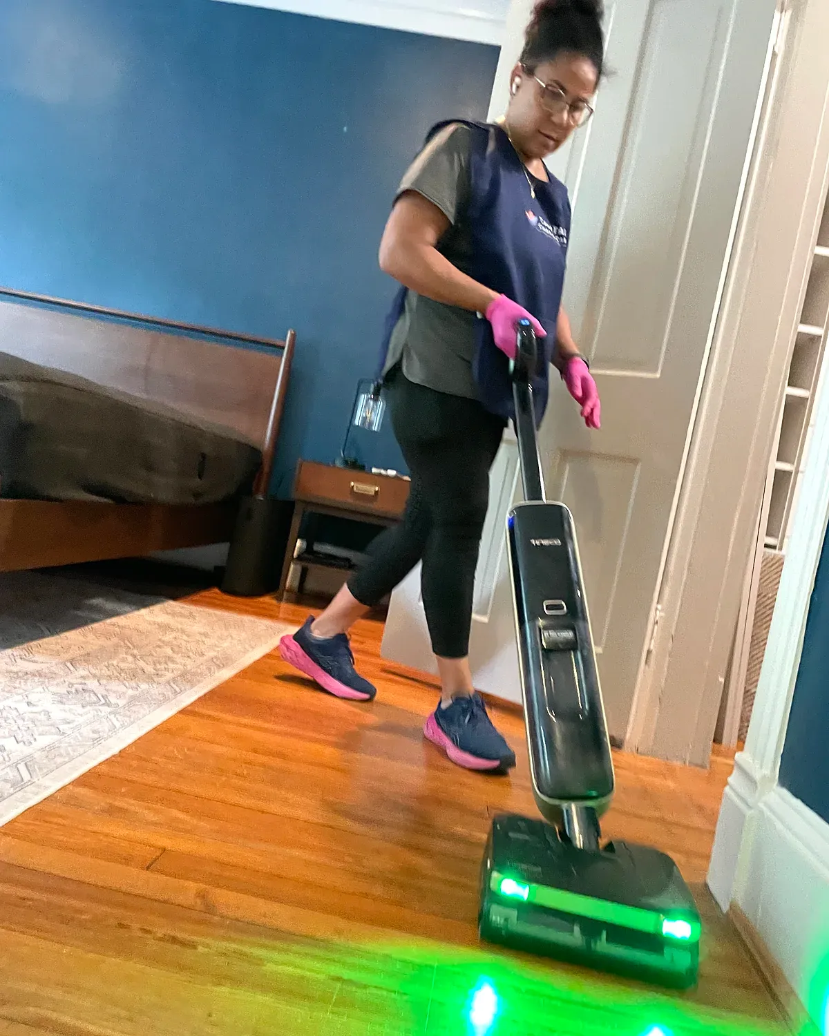 Capital Clean Care team member professionally cleaning hardwood floors in a Bethesda-area home