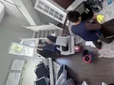 Two Capital Clean Care employees cleaning a living room on a scheduled visit
