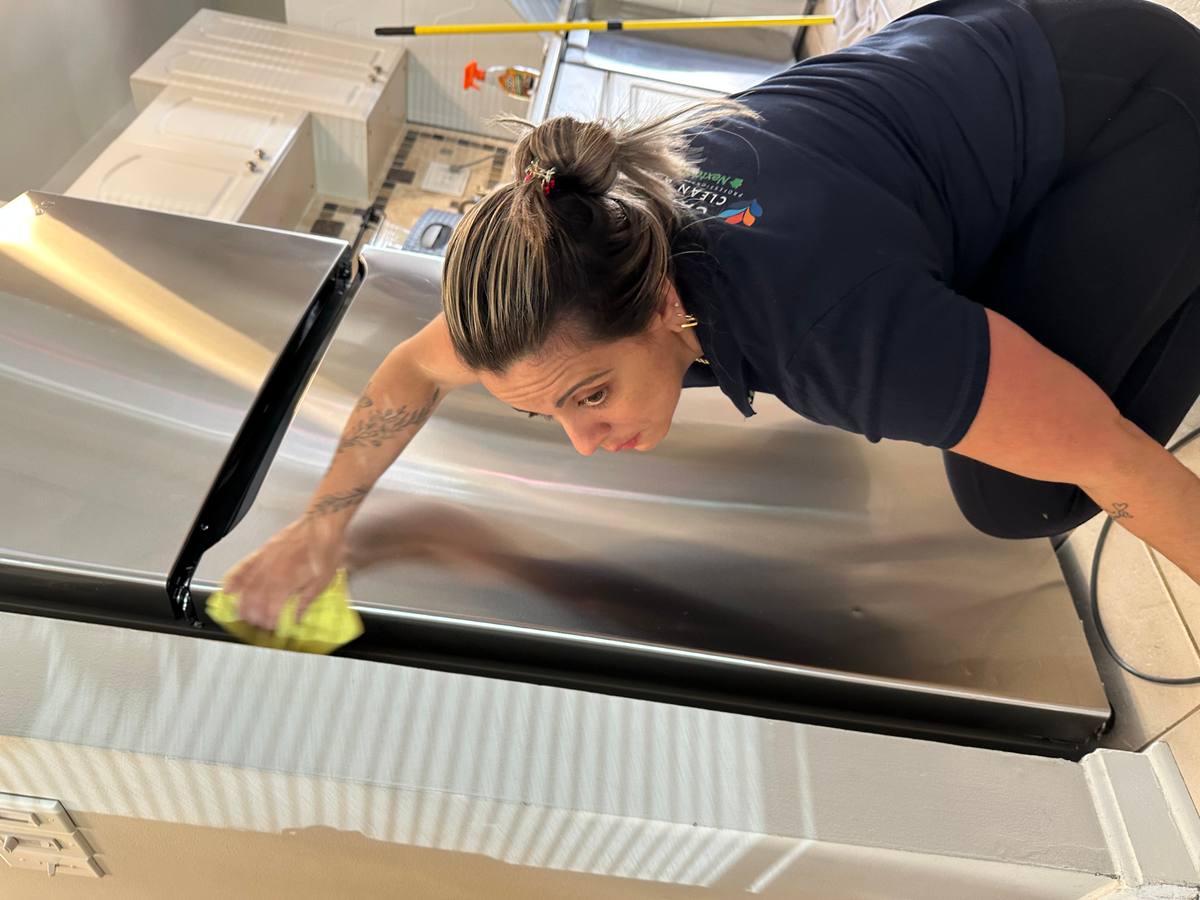 Cleaner performing white-glove inspection polishing stainless steel appliance