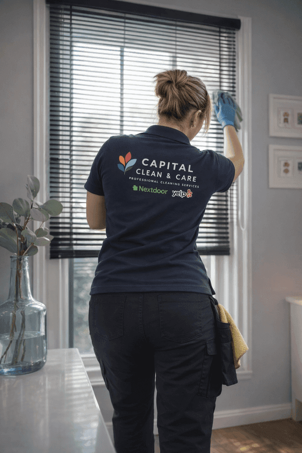 Cleaner dusting window blinds from top to bottom